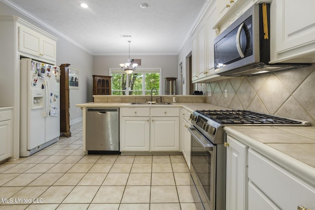 262 Geneva Blvd, Madison, MS 39110 - kitchen featuring appliances with stainless steel finishes, decorative backsplash, a peninsula, light tile patterned flooring, and white cabinetry
