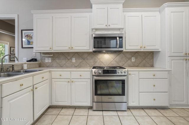 262 Geneva Blvd, Madison, MS 39110 - kitchen with appliances with stainless steel finishes, light countertops, decorative backsplash, white cabinets, and ornamental molding