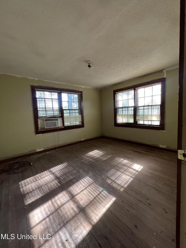 4595 Lucius Taylor Rd, Como, MS 38619 - spare room featuring a textured ceiling, hardwood / wood-style floors, cooling unit, and baseboards