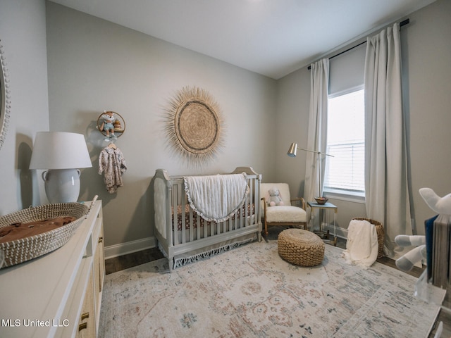 10501 Glade Cv, Gulfport, MS 39503 - bedroom featuring a nursery area and wood finished floors