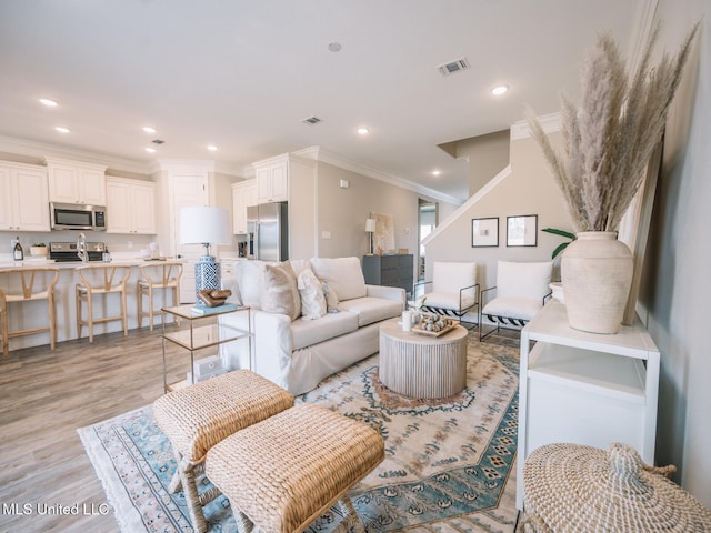 10501 Glade Cv, Gulfport, MS 39503 - living room with ornamental molding, light wood-style flooring, and recessed lighting