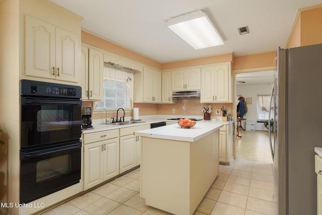 kitchen featuring sink, light tile patterned floors, black appliances, and a center island