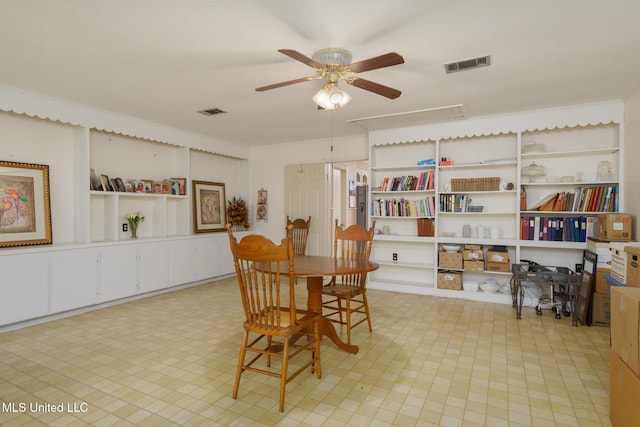 dining room with built in shelves and ceiling fan