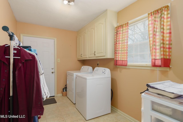 laundry room featuring cabinets and washing machine and dryer