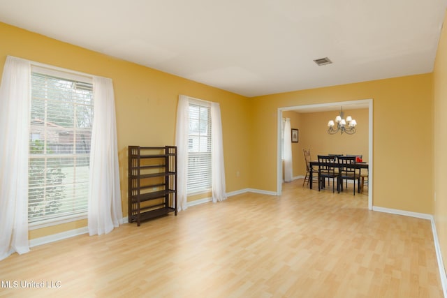 interior space featuring an inviting chandelier and hardwood / wood-style floors