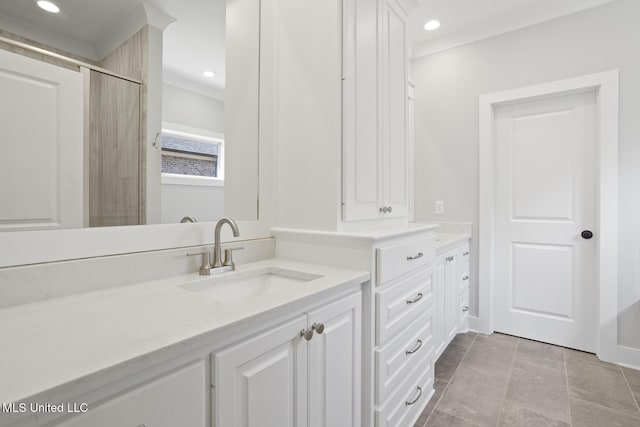 bathroom featuring baseboards, recessed lighting, vanity, and crown molding