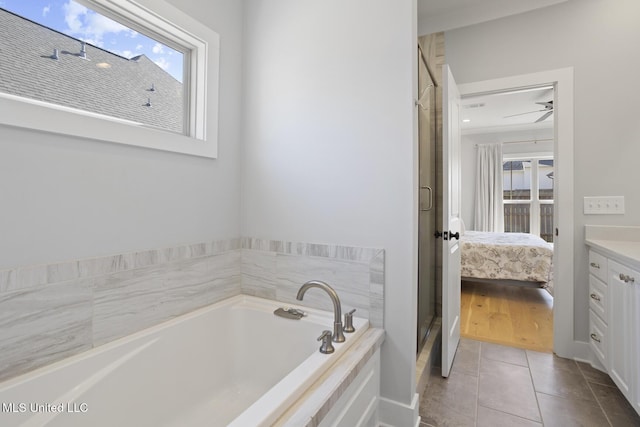 ensuite bathroom with tile patterned flooring, vanity, a bath, and ensuite bathroom