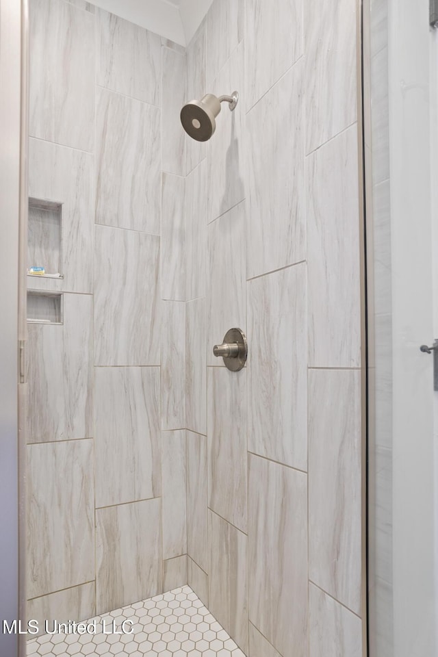 bathroom with tiled shower