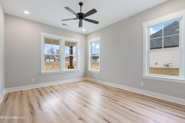 empty room featuring ceiling fan and light hardwood / wood-style floors