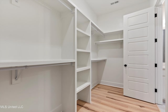 walk in closet featuring hardwood / wood-style flooring