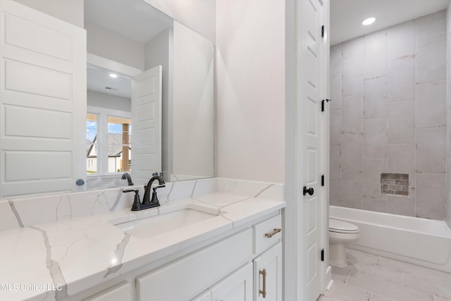 full bathroom with tile patterned floors, vanity, toilet, and tiled shower / bath combo