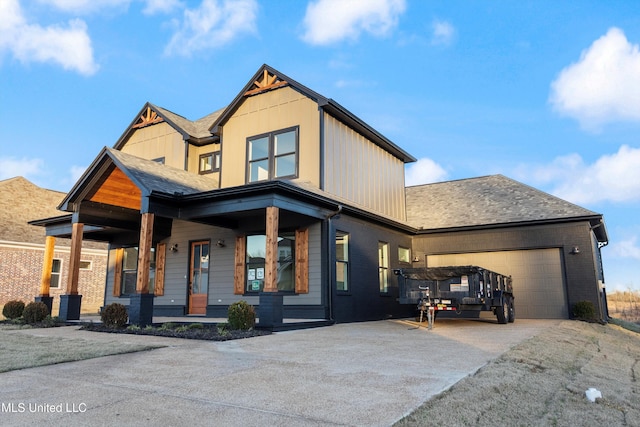 view of front of home featuring a porch and a garage