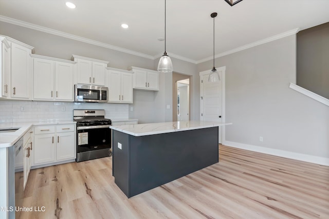 kitchen featuring white cabinets, appliances with stainless steel finishes, and a center island