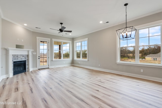 unfurnished living room featuring a tile fireplace, light wood-type flooring, and plenty of natural light