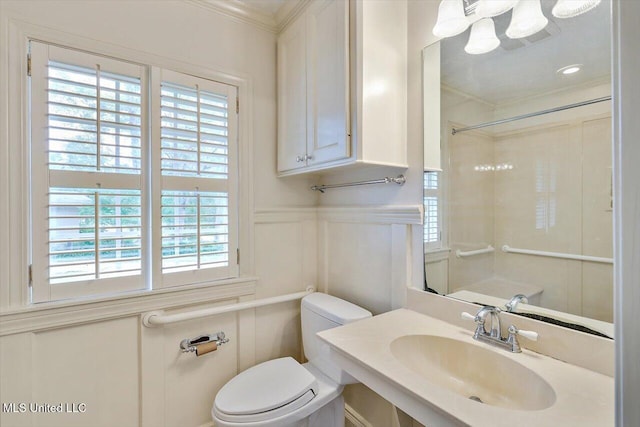 4638 Katherine Blvd, Jackson, MS 39211 - bathroom with crown molding, a sink, healthy amount of natural light, toilet, and a decorative wall