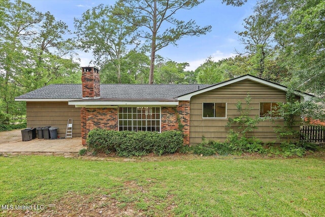 4638 Katherine Blvd, Jackson, MS 39211 - back of property featuring a yard, a chimney, a patio, roof with shingles, and brick siding