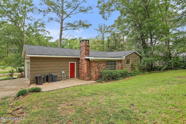 4638 Katherine Blvd, Jackson, MS 39211 - rear view of house featuring a chimney, a lawn, and a shingled roof