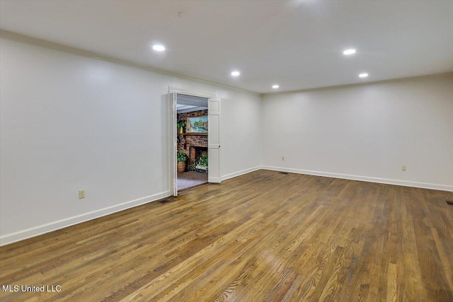 4638 Katherine Blvd, Jackson, MS 39211 - empty room with recessed lighting, baseboards, wood finished floors, a brick fireplace, and ornamental molding