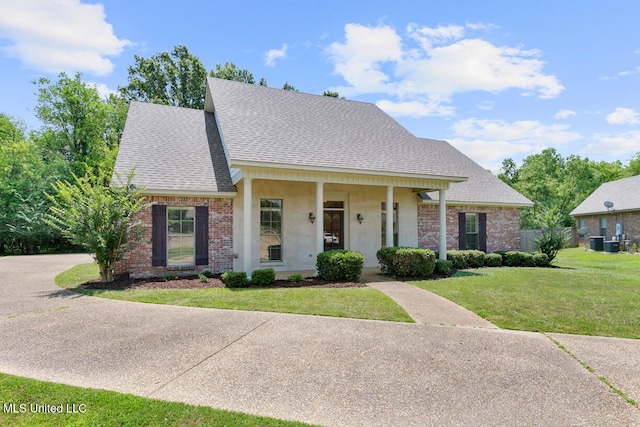 view of front of home featuring covered porch, central AC unit, and a front lawn