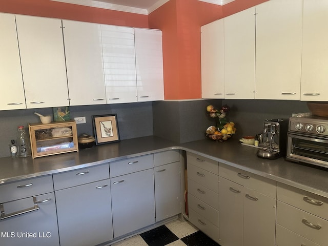 kitchen with white cabinetry and ornamental molding