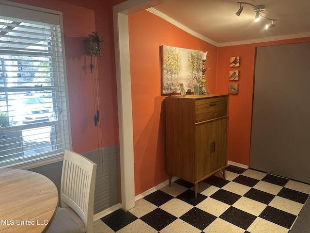 dining space featuring crown molding