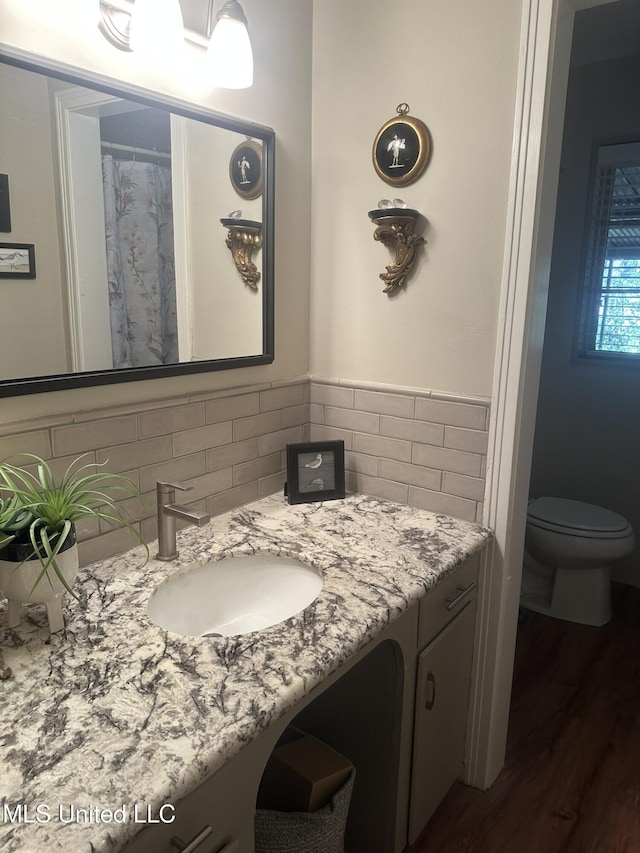 bathroom with vanity, hardwood / wood-style floors, and toilet