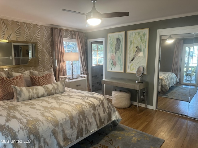 bedroom featuring hardwood / wood-style flooring, crown molding, ceiling fan, and multiple windows