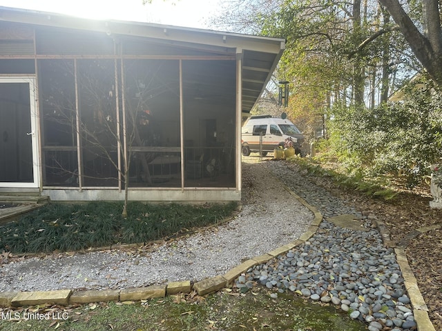 view of property exterior featuring a sunroom