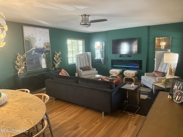 living room featuring hardwood / wood-style flooring and ceiling fan