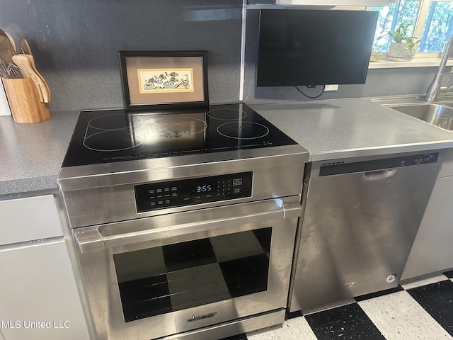 kitchen with sink and appliances with stainless steel finishes