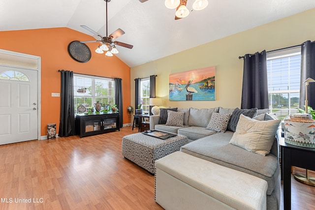 living room featuring light hardwood / wood-style floors, vaulted ceiling, and ceiling fan