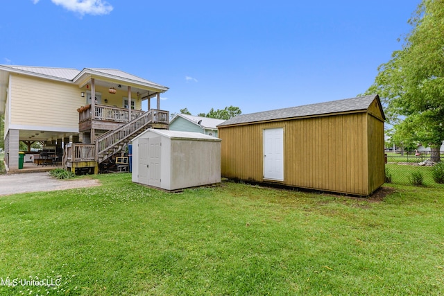 view of yard featuring a shed and a porch