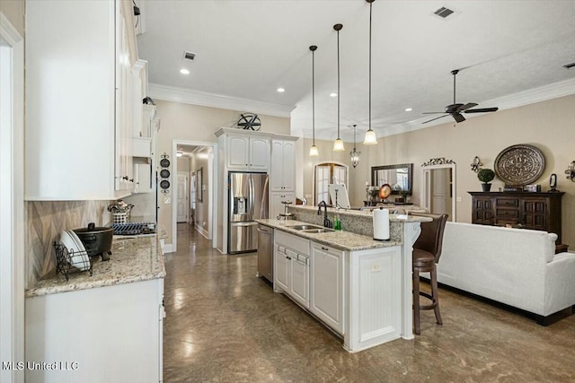 kitchen featuring stainless steel appliances, visible vents, open floor plan, white cabinets, and a sink