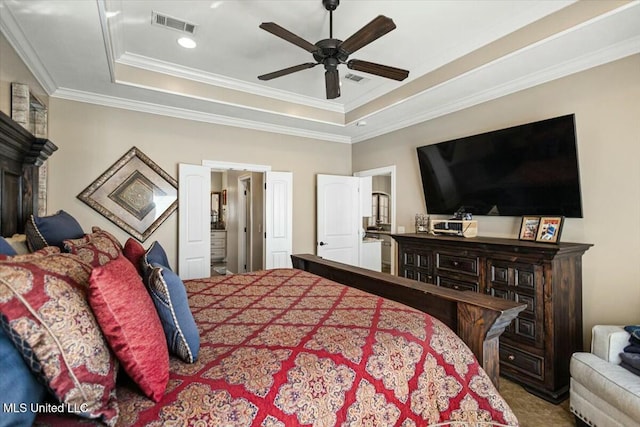 carpeted bedroom featuring a ceiling fan, crown molding, visible vents, and a tray ceiling