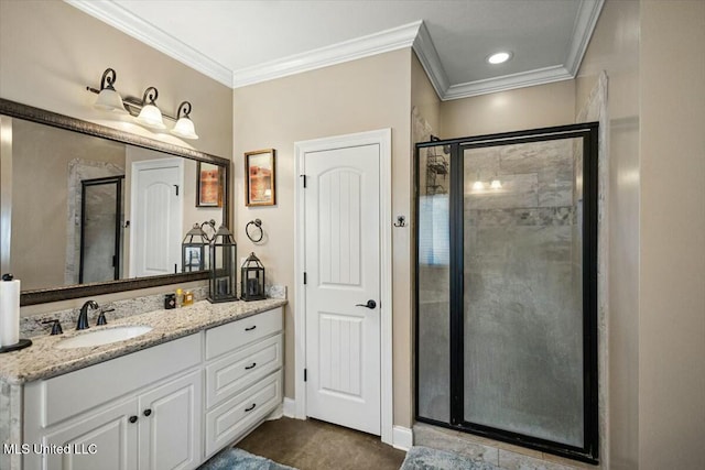 bathroom with ornamental molding, a stall shower, vanity, and baseboards