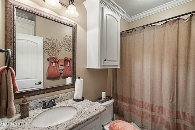 bathroom featuring ornamental molding, curtained shower, vanity, and toilet