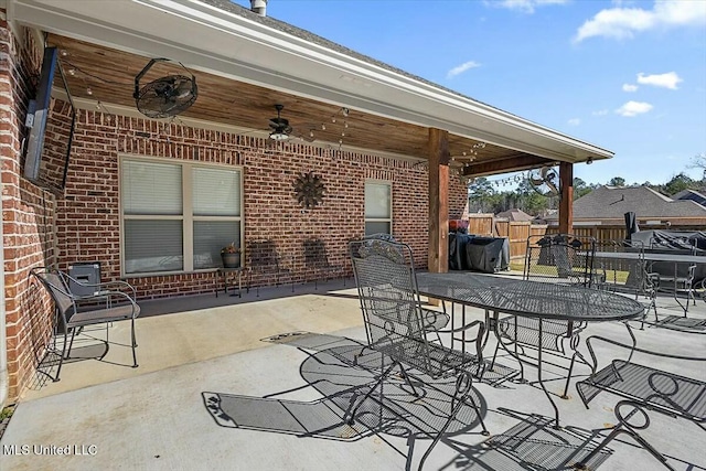 view of patio / terrace featuring outdoor dining area, fence, and a ceiling fan