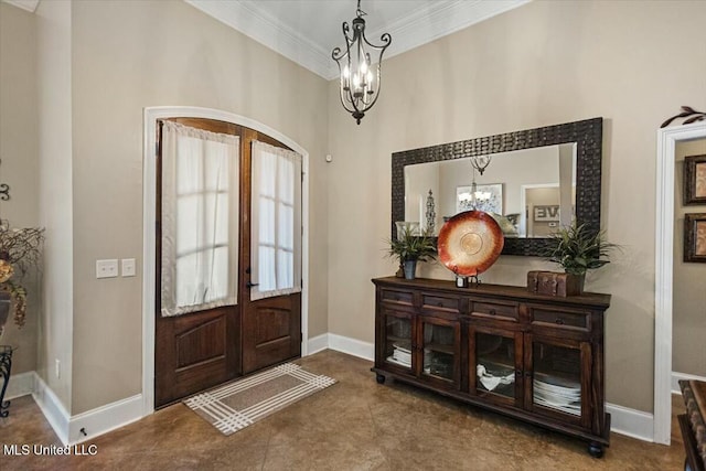 foyer featuring ornamental molding, french doors, baseboards, and an inviting chandelier