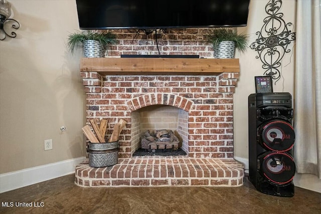 details with a brick fireplace and baseboards