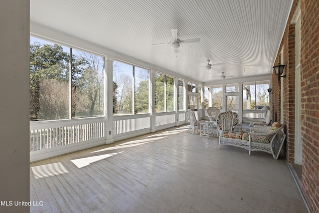 unfurnished sunroom featuring ceiling fan