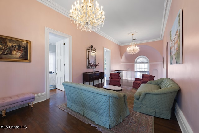 living area with crown molding, a notable chandelier, baseboards, and wood finished floors