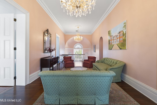 sitting room with a chandelier, dark wood-type flooring, and ornamental molding