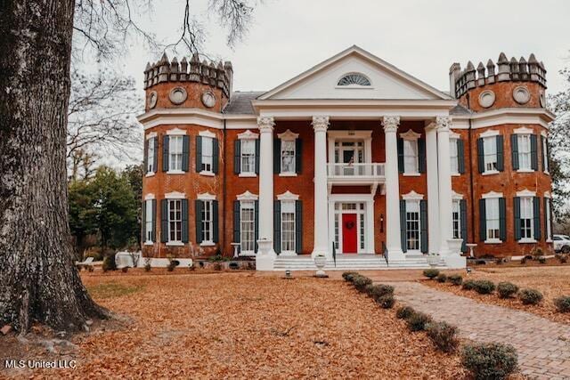 neoclassical home with a balcony