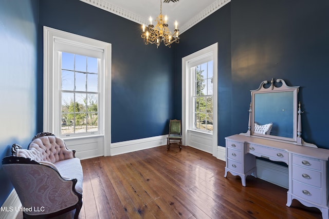 sitting room with dark wood-style floors, baseboards, visible vents, and a notable chandelier