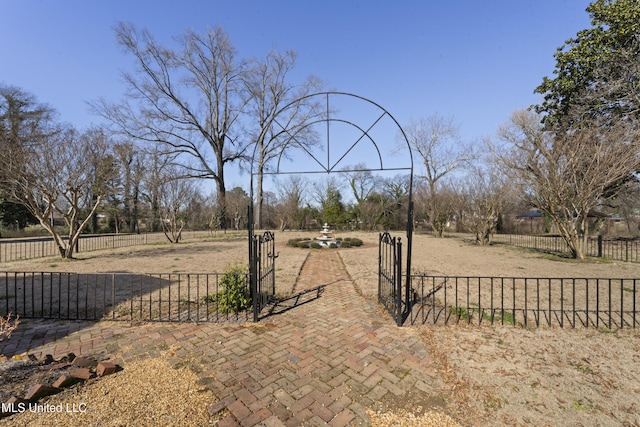 view of yard with fence and a rural view