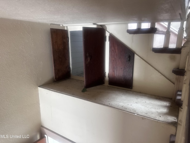1003 41st Ave, Gulfport, MS 39501 - staircase featuring a textured wall