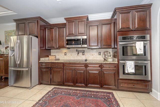 kitchen featuring backsplash, light stone countertops, ornamental molding, light tile patterned floors, and stainless steel appliances