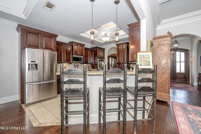 kitchen with crown molding, light wood-style floors, arched walkways, and appliances with stainless steel finishes