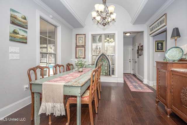 dining area with baseboards, a chandelier, dark wood finished floors, ornamental molding, and vaulted ceiling