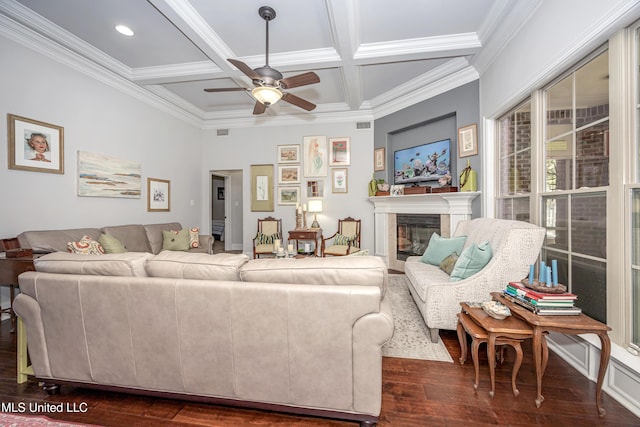 living area featuring coffered ceiling, dark wood finished floors, beam ceiling, a glass covered fireplace, and crown molding